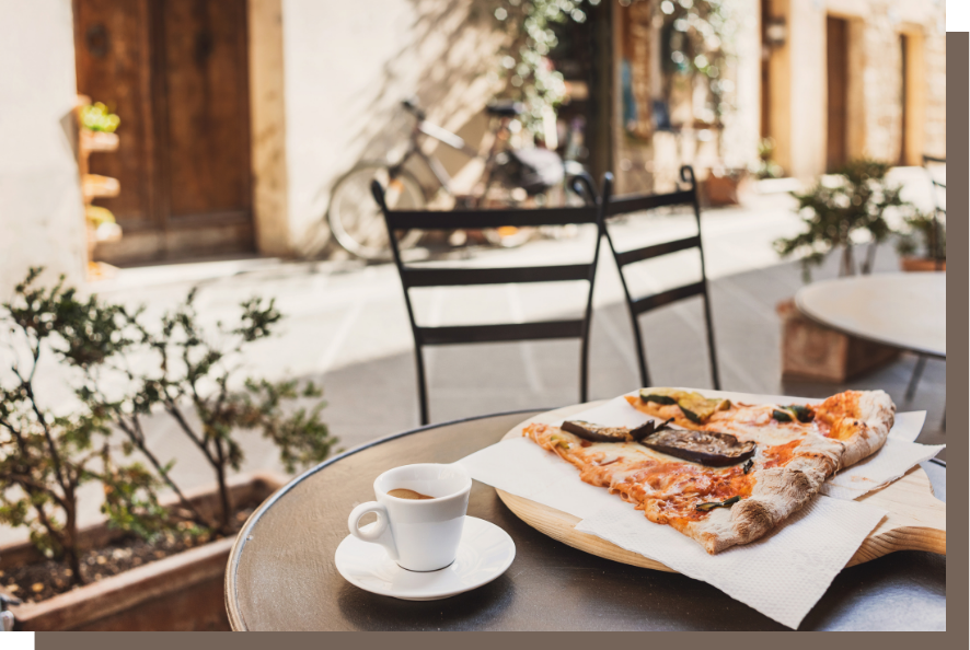Make people hungry for your offer A sunny patio with chairs, espresso, and slices of pizza