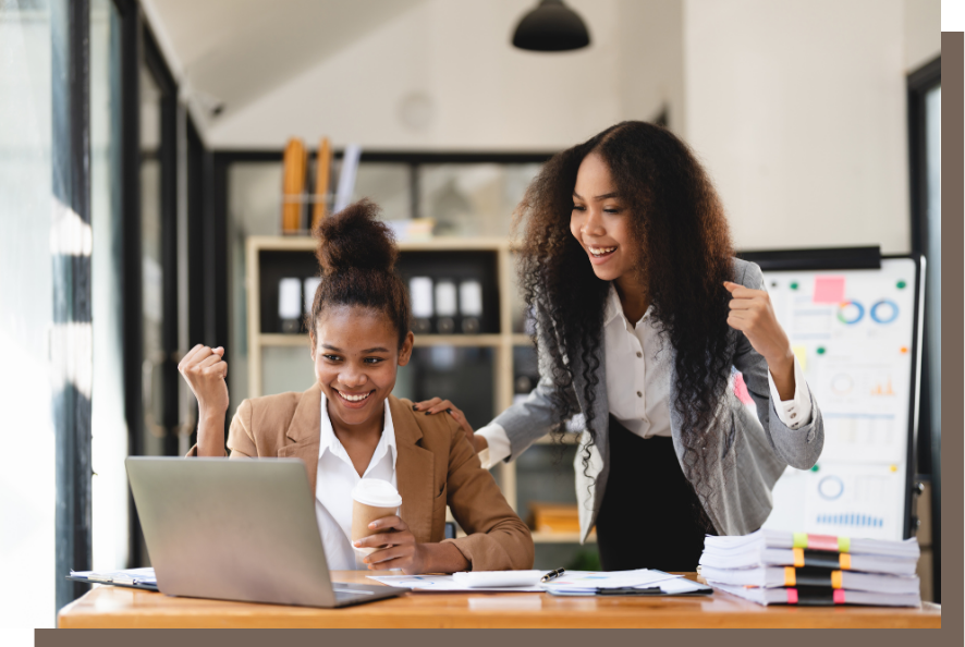 Excitement, passion and enthusiasm gets clients 2 Black women in an office, looking excitedly at a computer screen